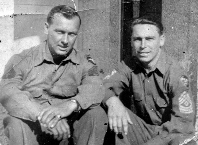 Technical Sergeant Tony Sorgent (left) relaxes with First Sergeant Joe Cotten. Sorgent constantly scrounged for food and made meals for the men in Cotten’s company.