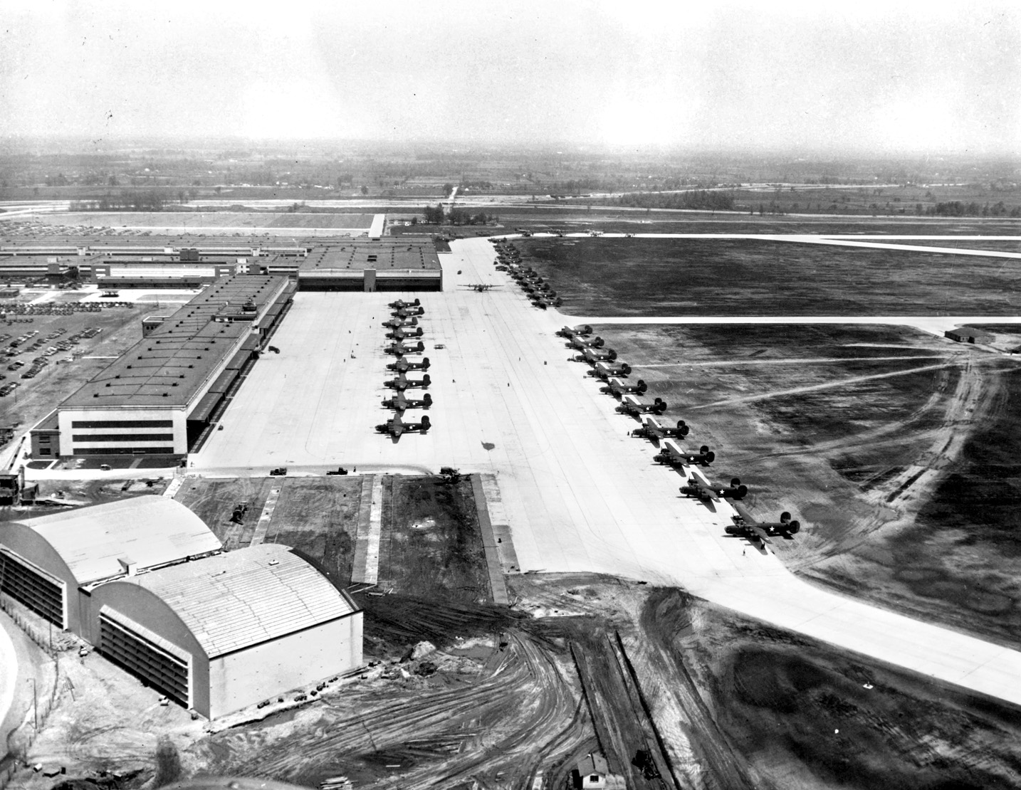 Newly manufactured B-24s sit on the tarmac at the Willow Run facility, waiting to be flown by ferry pilots to their fianl destinations. Willow Run remains an operational airport today.