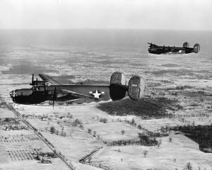 Two B-24 Liberator bombers photographed on a test flight near Ford Motor Company’s Willow Run factory in Michigan. Although Consolidated won the contract, they were unable to produce all of the B-24s needed so production was outsourced to other companies such as Ford.