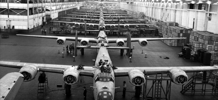 Stretching as far as the eye can see in Ford’s enormous, mile-long Willow Run factory, a line of B-24s undergo assembly. Ford boasted that its 42,000 employees turned out a complete B-24 every 63 minutes.