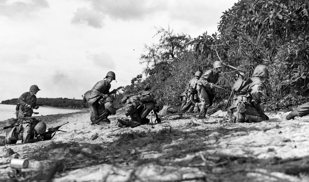  Two Marines (left and center) fall as they are hit by sniper fire while coming ashore.