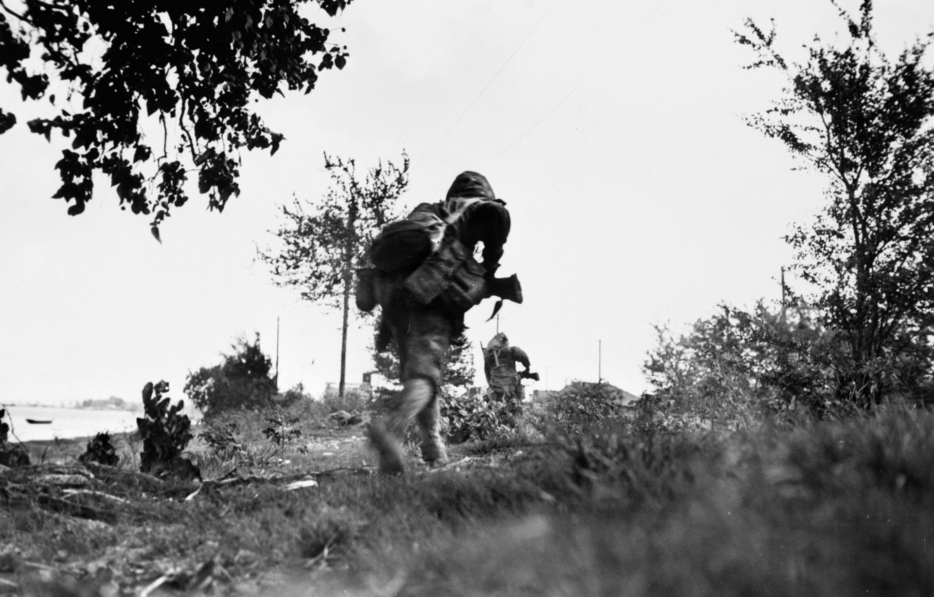 Hurrying to avoid enemy fire, U.S. Marines dash forward, June 24, 1944.v