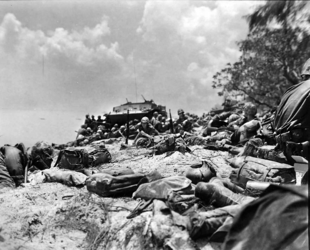 Marines seek shelter on Red Beach No. 2 before moving inland to engage the enemy.