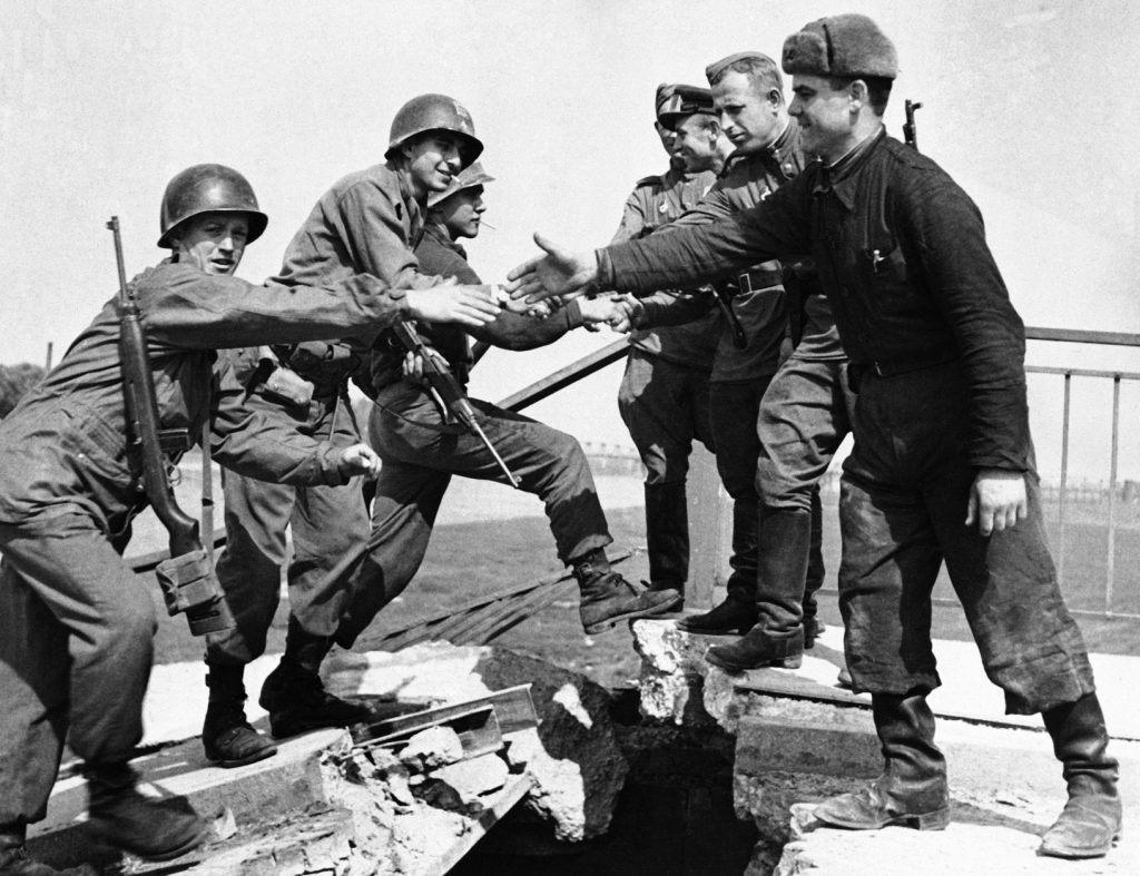 Famous photo of GIs of the U.S. 69th Infantry Division shaking hands with a patrol from the 58th Guards Rifle Division on a destroyed bridge over the Elbe River at Torgau, April 27, 1945.