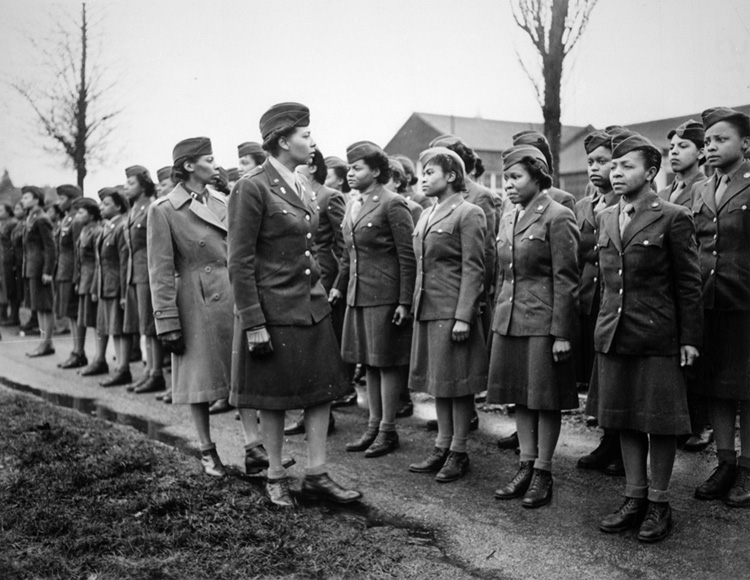  Somewhere in England, Major Charity E. Adams and Captain Abbie N. Campbell inspect a postal battalion. Adams was the first African American WAC officer and the highest-ranking African American woman during the war.