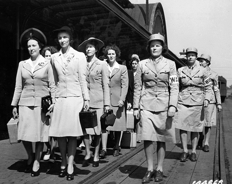 Still in stylish civilian clothes, a group of Women’s Army Auxiliary Corps recruits arrives at Fort Des Moines, Iowa, 1942. 