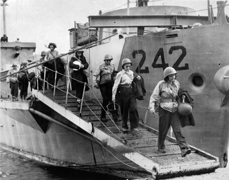 The first Army nurses arrive on Pantelleria shortly after Allied assault forces secured the Mediterranean island in June 1943. OPPOSITE: Worried buddies look on as Ensign Jane Kendeigh, a Navy flight nurse, comforts a badly wound