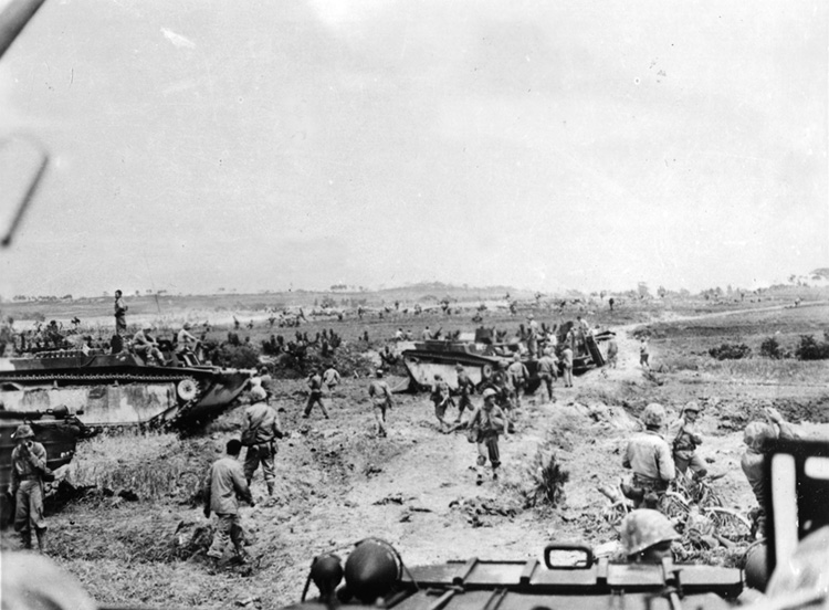 Having landed against no enemy opposition, Marines seem relaxed. But rather than trying to repulse the landings, the Japanese allowed the Americans to advance inland before counterattacking.