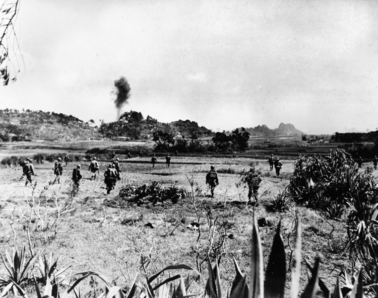 Smoke from a naval bombardment rises as American infantrymen press inland from the invasion beaches against only light opposition for the first several days of the campaign.
