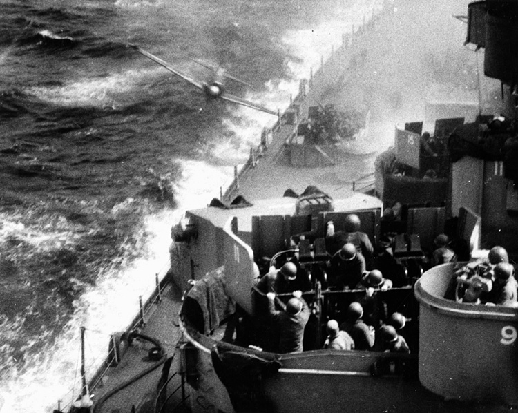 Sailors in their antiaircraft gun tub aboard the USS Missouri brace for the impact of a kamikaze suicide pilot, April 11, 1945.