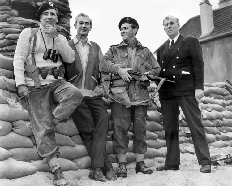 A publicity photo from the Hollywood film The Longest Day shows Peter Lawford (left) with his character, the real-life Lord Lovat, and Richard Todd (who was an actual veteran of the Normandy fighting) and his character Major John Howard. Both Lovat and Howard were technical advisors on the film.