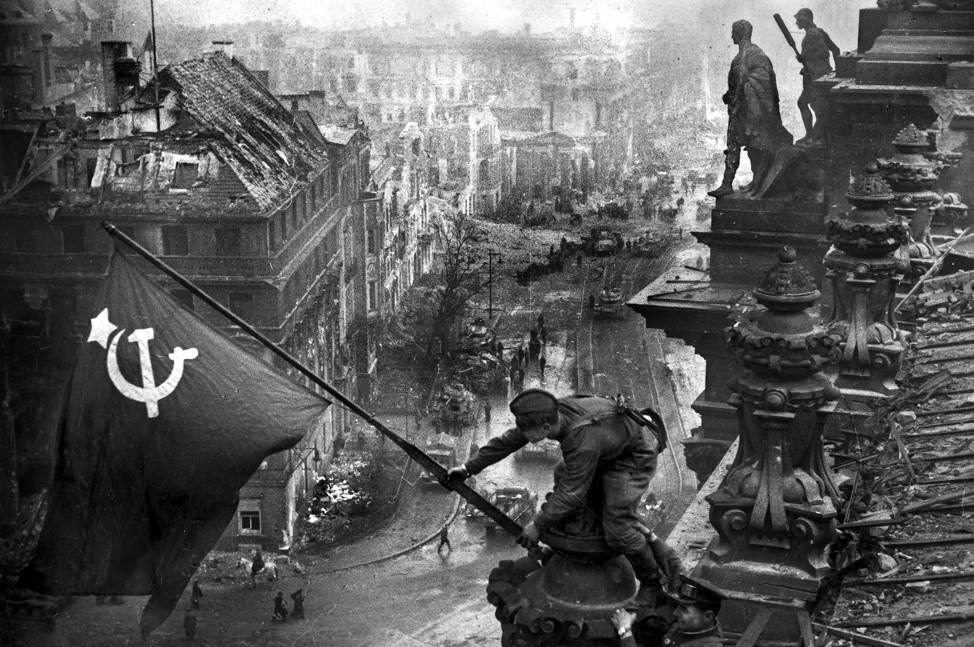 To the Soviets, this photo by Yevgeny Khaldei of Red Army soldiers raising the Soviet Union flag on top of the Reichstag over battered Berlin was as iconic and symbolic of victory as the February 1945 shot of U.S. Marines raising the Stars and Stripes atop Mount Suribachi at <a href=