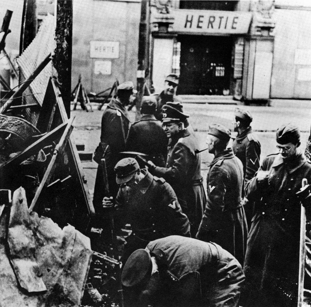 German soldiers build a barricade across a Berlin street in hopes of slowing the Red Army invasion. In addition to the regular army, thousands of old men and young boys volunteered or were pressed into service to defend the capital. 