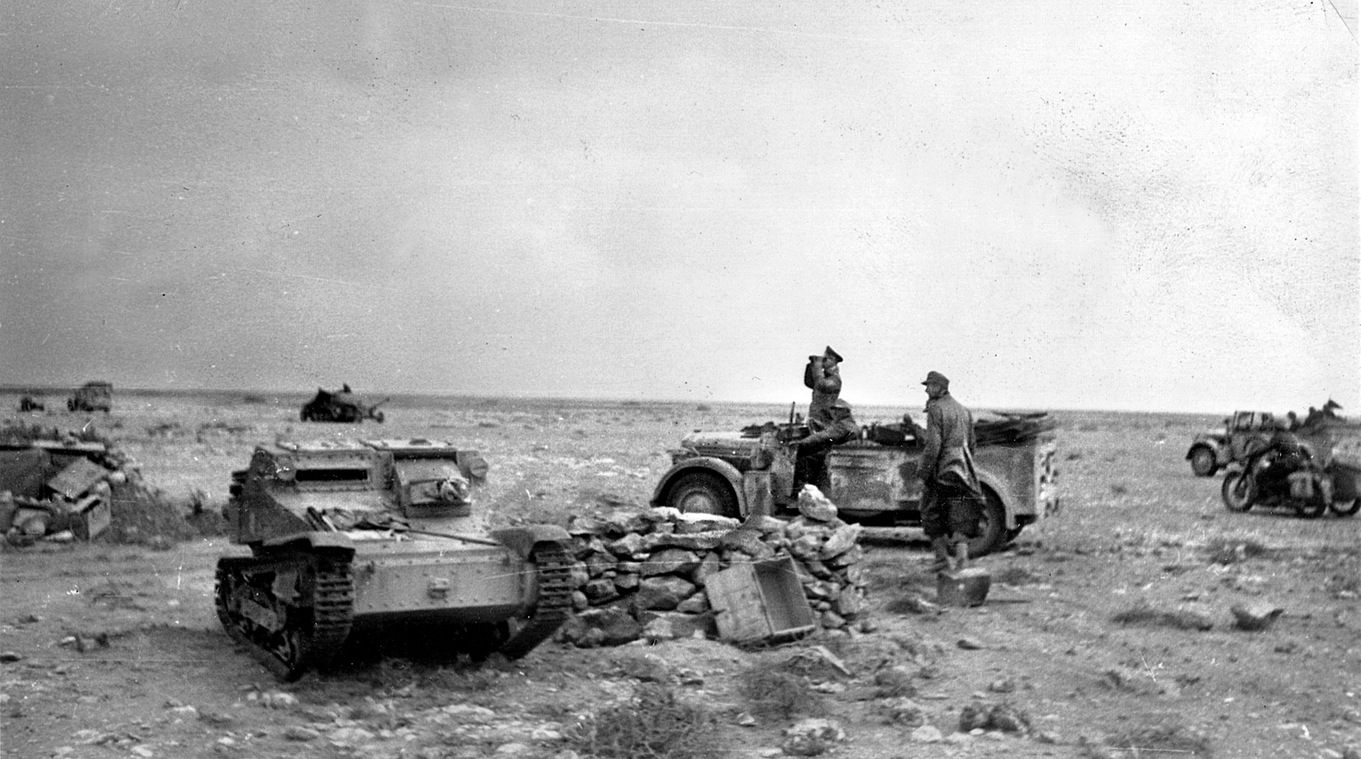 Field Marshal Rommel reconnoiters the battleground from a command vehicle. An abandoned <a href=