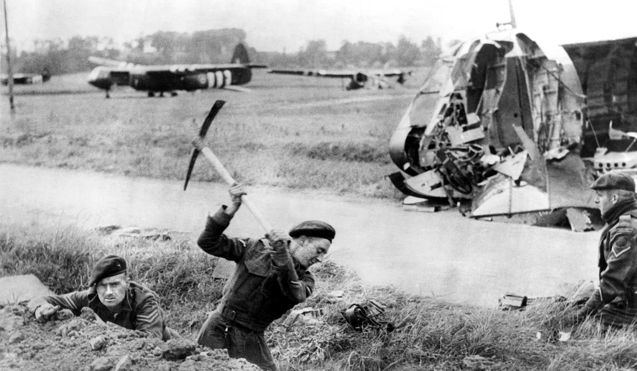 British airborne troops, probably brought to France by the Horsa gliders behind them, prepare defensive positions in anticipation of German counterattacks near Ranville.