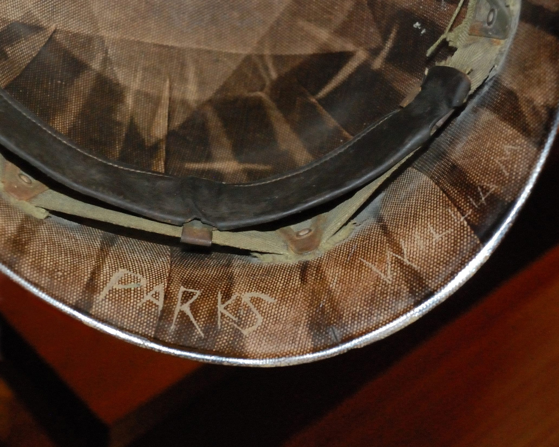 “Parks William” is visibly etched inside the helmet liner that Parks lost during the Battle of the Bulge in 1944.  Parks died in 1993, but the lost artifact was eventually presented to his family.