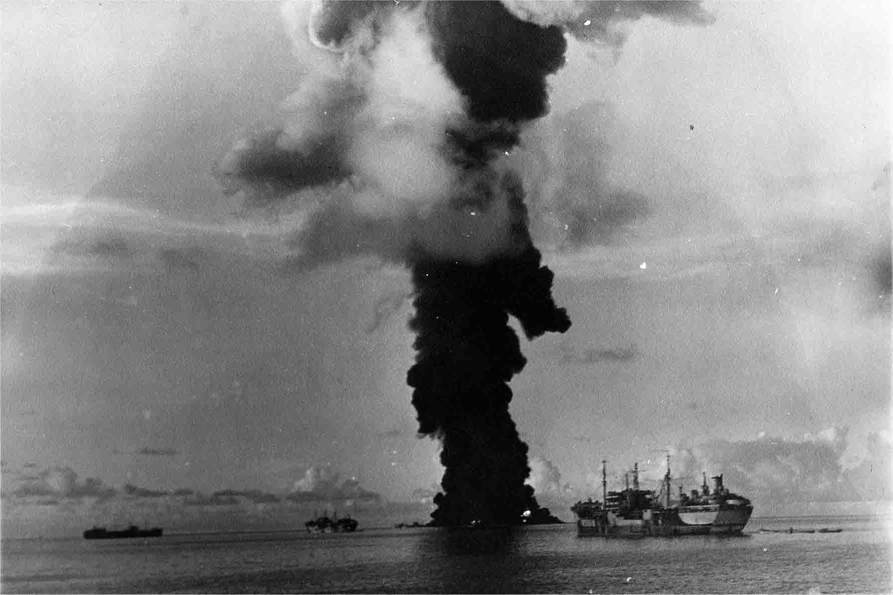 The fleet oiler USS Mississinewa burns furiously after a successful attack by Kaiten against the U.S. anchorage at Ulithi Atoll in November 1944.