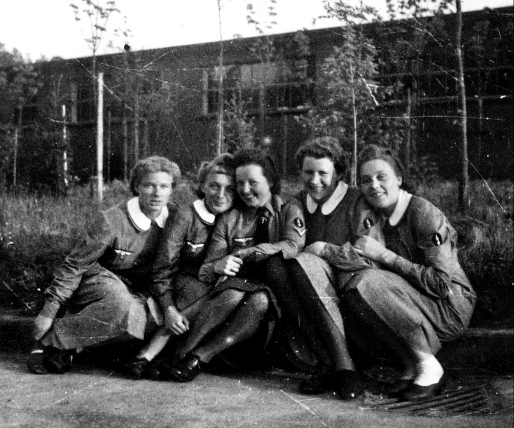 The lightning flash insignia worn on their uniform indicate that this group of young female auxiliary workers served in a Luftwaffe communications detachment (Nachrichtenhelferinnen). Other less-complimentary monikers, created by their male colleagues, included Blitzmaus (lightning mouse) and Blitznutte (lightning prostitute).