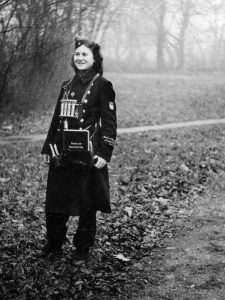 Many women worked on buses and trains like the girl seen here in a photo sent to her by a friend who addressed her as Ursa. The book she carries indicates the location is Cologne while the script sewn on her sleeve relates to her war service—one of the many Helferin or female volunteers who increasingly provided Germany’s infrastructure with its workforce.