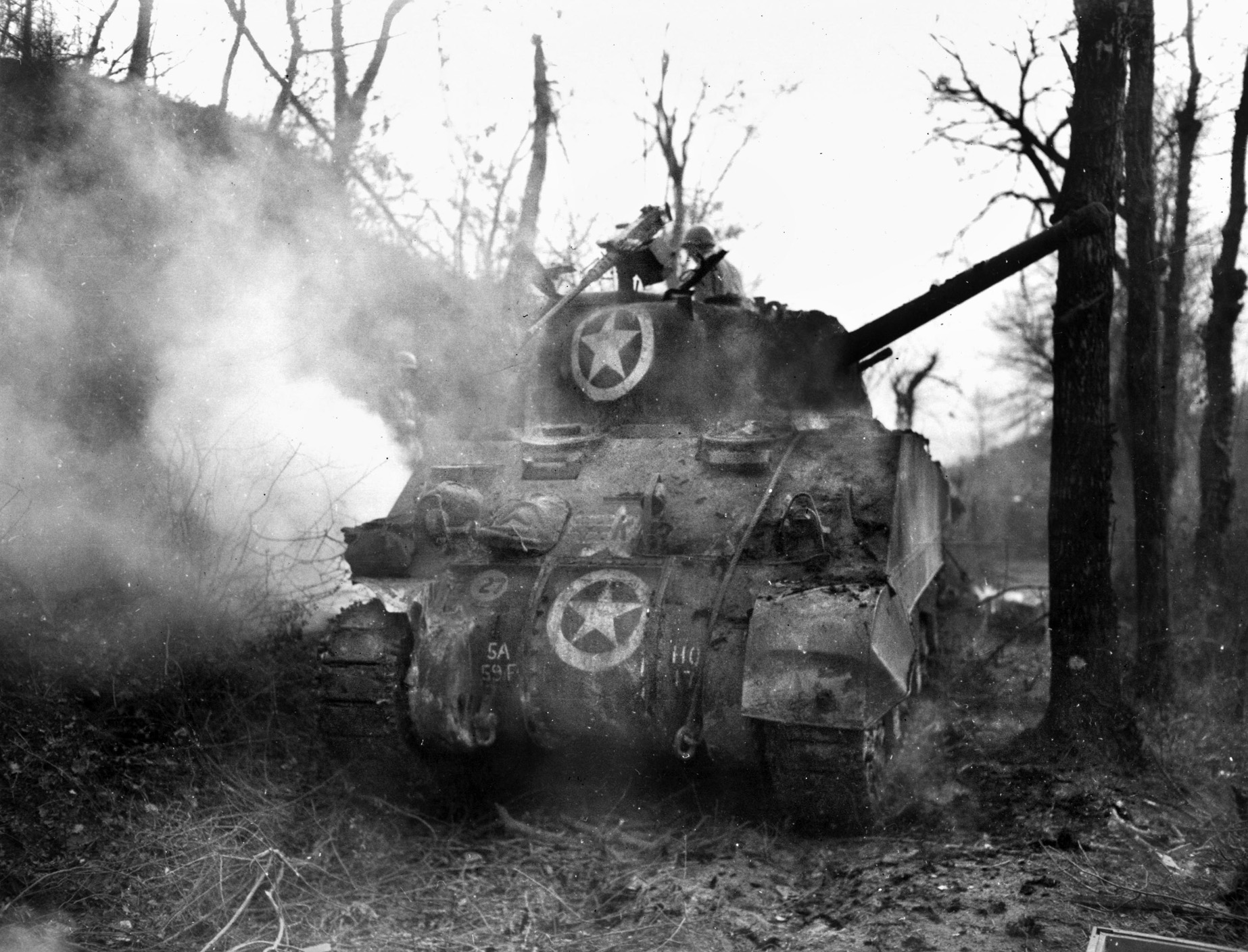 An A-4 Sherman medium tank burns after being hit by German fire during the battle for Anzio. Muddy fields confined most armor to the roads, making them easy targets.