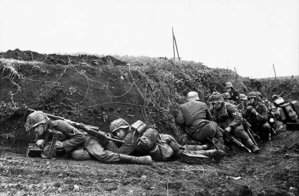 German infantrymen take cover from Allied shelling in a creekbed near Anzio. The Americans wondered if the German infantrymen were drunk when they attacked across the open ground.