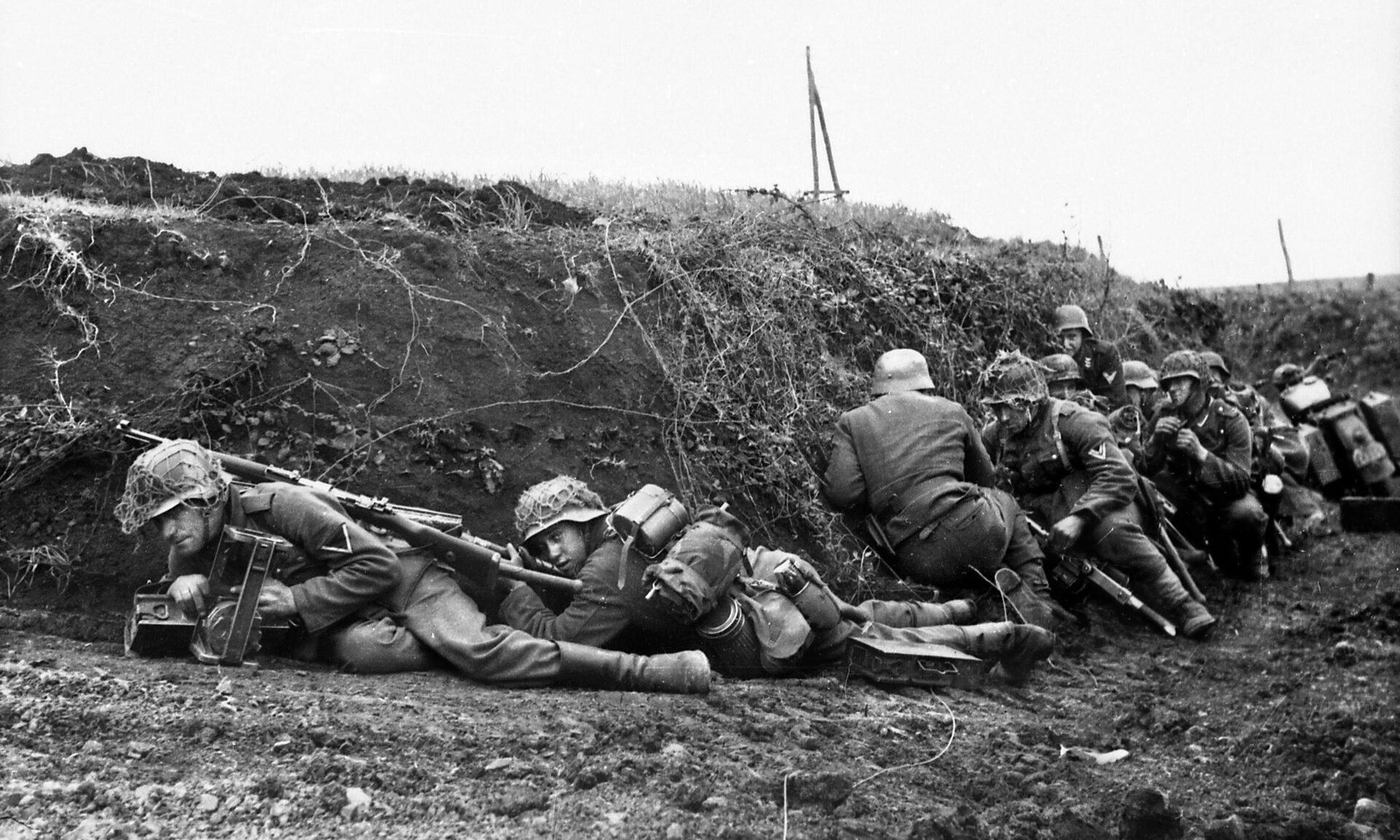 German infantrymen take cover from Allied shelling in a creekbed near Anzio. The Americans wondered if the German infantrymen were drunk when they attacked across the open ground.