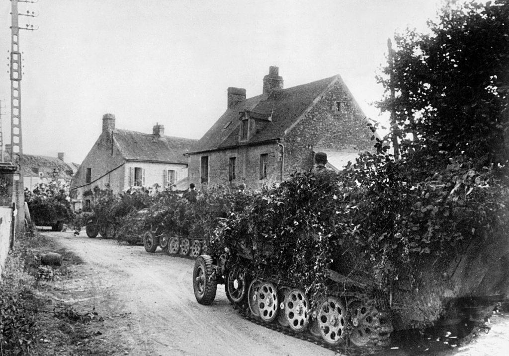  Heavily camouflaged to protect against Allied air attacks, a convoy of German panzers hit the road during the time of the Falaise battle. 