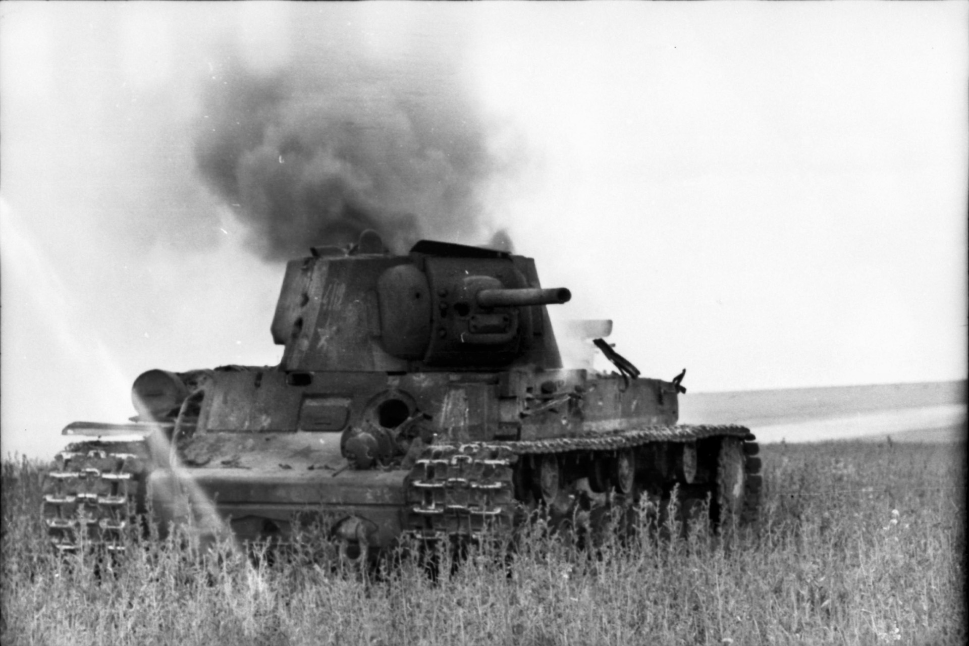 A Soviet tank, destroyed in a futile attempt to stem the Nazi tide during the early days of Case Blue, billows smoke on the Russian steppe.