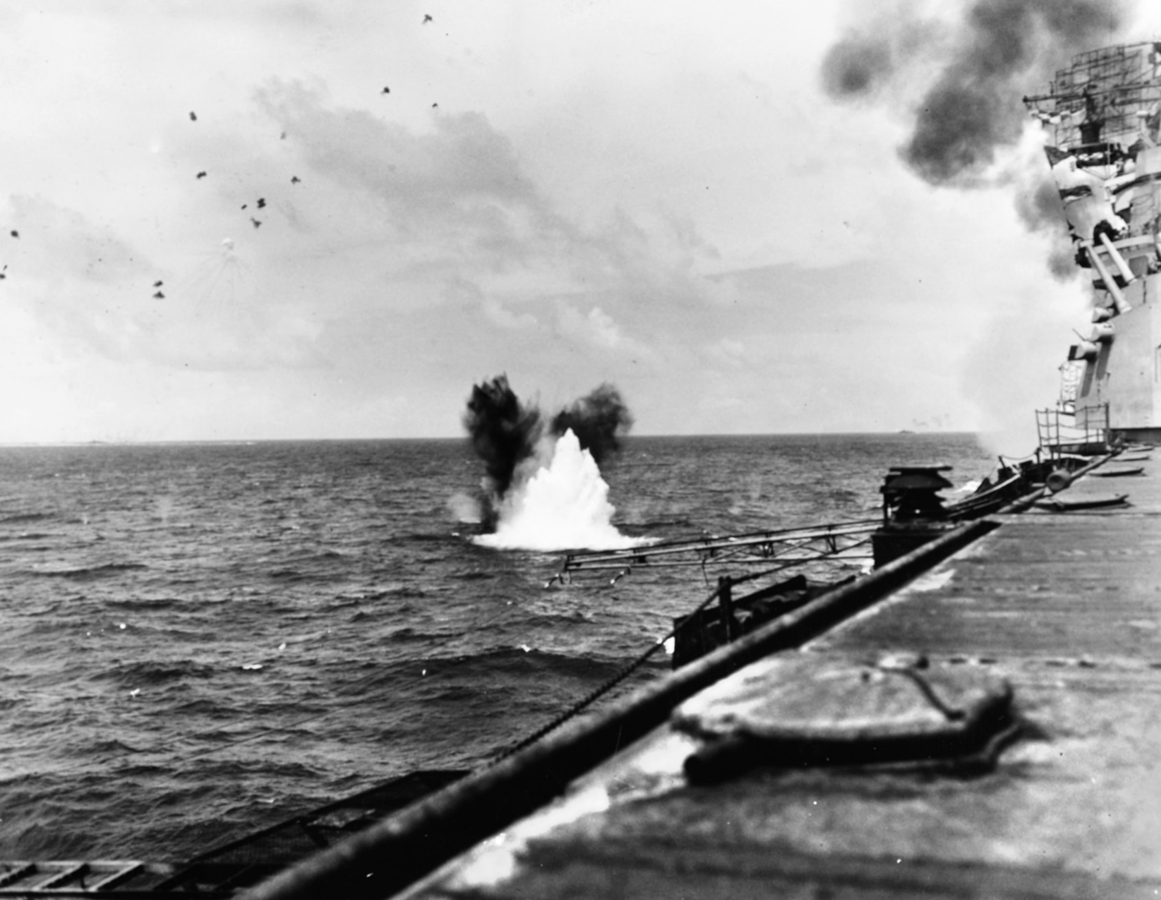 During early action in the battle, a Japanese bomb explodes close to the American aircraft carrier Bunker Hill.