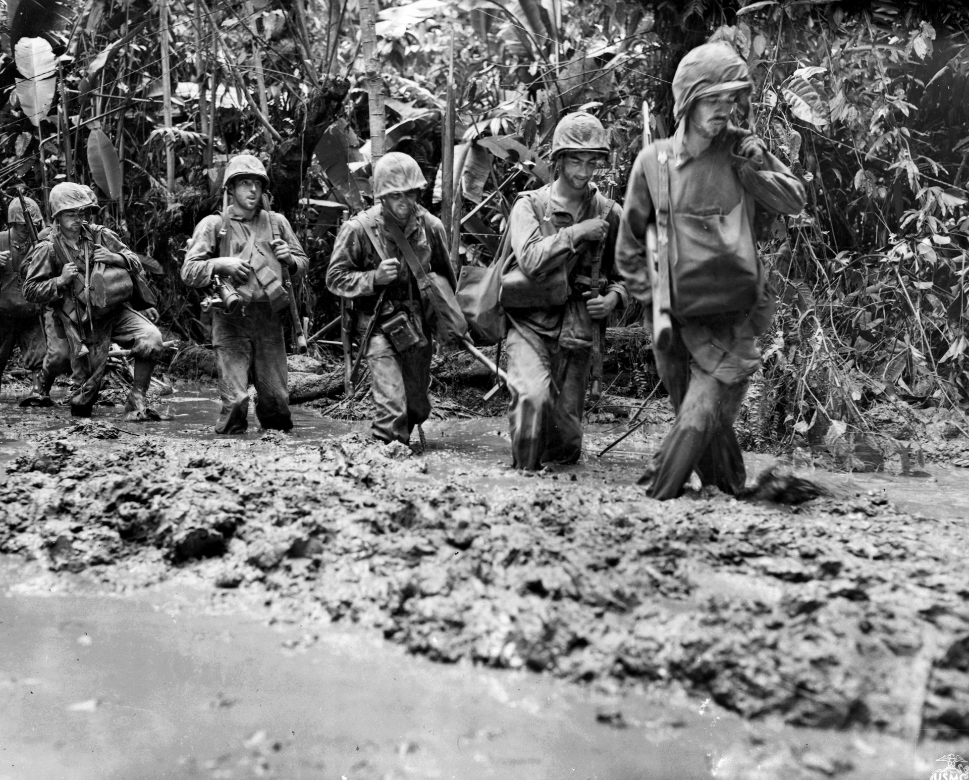 A Marine patrol slogs through knee-deep mud during the effort to wrest Bougainville from the Japanese. The island provided Marine scout Larry Kirby’s first taste of combat, and the jungle proved a difficult adversary along with the Japanese.
