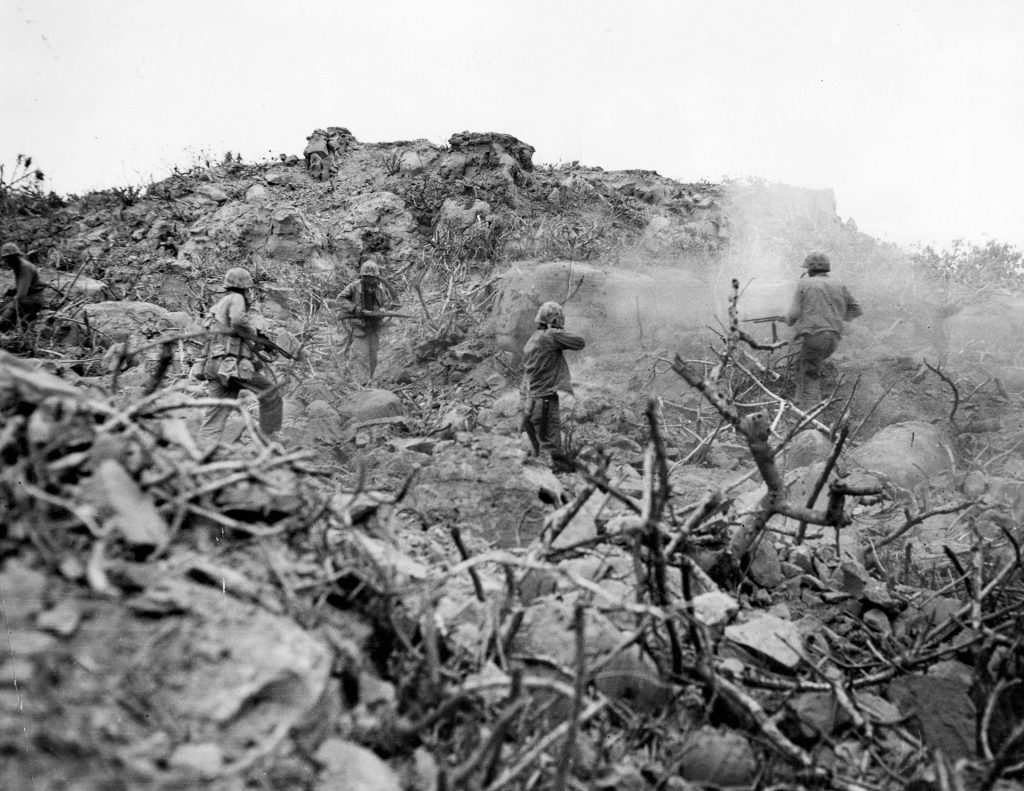 Wary of enemy defensive positions that could erupt at any moment, U.S. Marines climb rocky terrain on Iwo Jima. Kirby’s night patrol near Hill 362C bypassed several Japanese strongpoints that later opened in a torrent of fire amid the eerie light of a flare, and the battle for Hill 362C devolved into a fight for survival. 