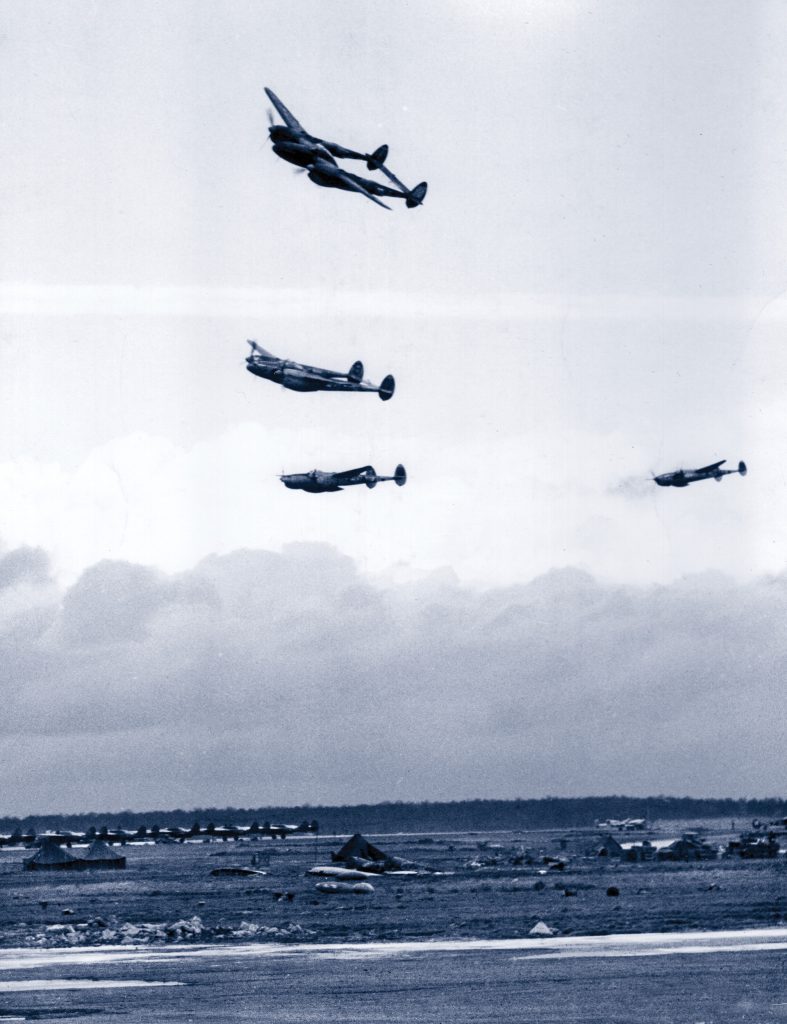 Lockheed P-38 Lightning fighters of the 9th Air Force return to their base after completing a tactical air-support mission against German forces impeding the progress of American troops on the Western Front.