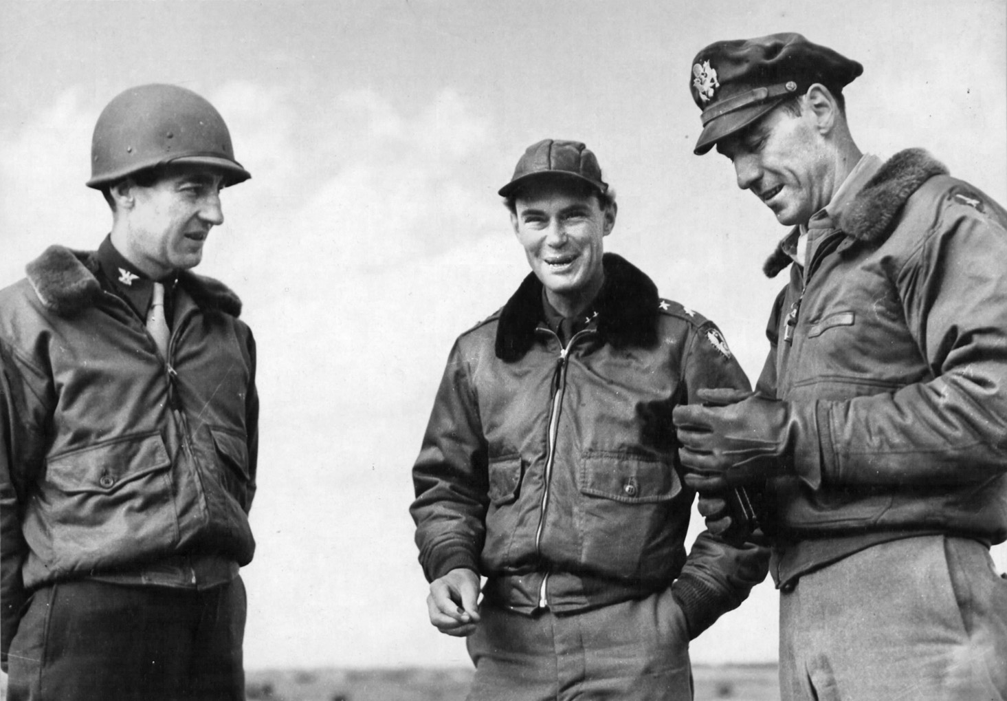 Commanders of two U.S. Army Air Forces fighter groups flying the versatile Lockheed P-38 fighter, Colonel Clinton Wasem of the 474th (left) and Colonel Howard Nichols of the 370th (right), confer with General Hoyt Vandenberg (center), commander of the U.S. Ninth Air Force, during operations on the European continent.