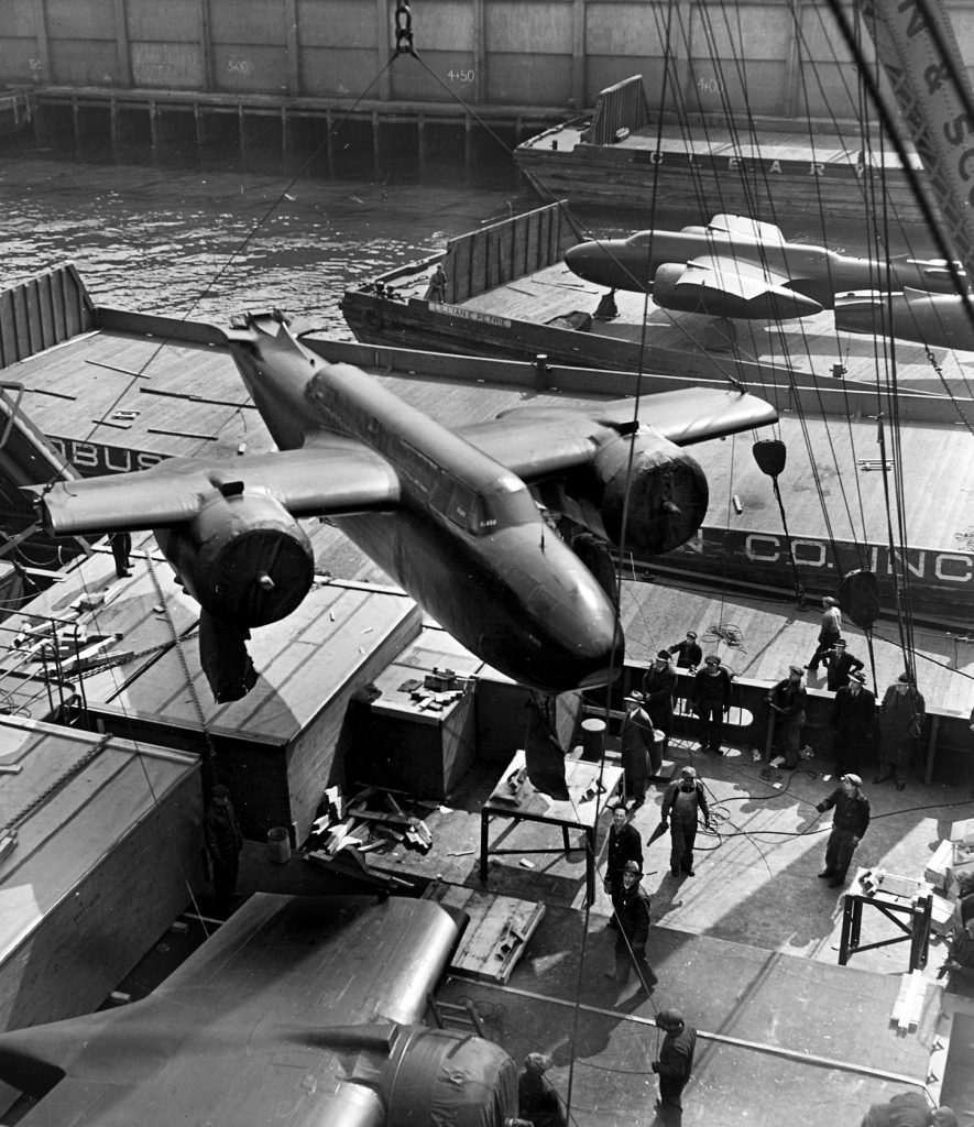Douglas A-20 bombers are shown partially constructed as they are loaded aboard a freighter for the long journey from the United States to a Russian port. The Lend-Lease program helped sustain the Soviet war effort against the Nazis.