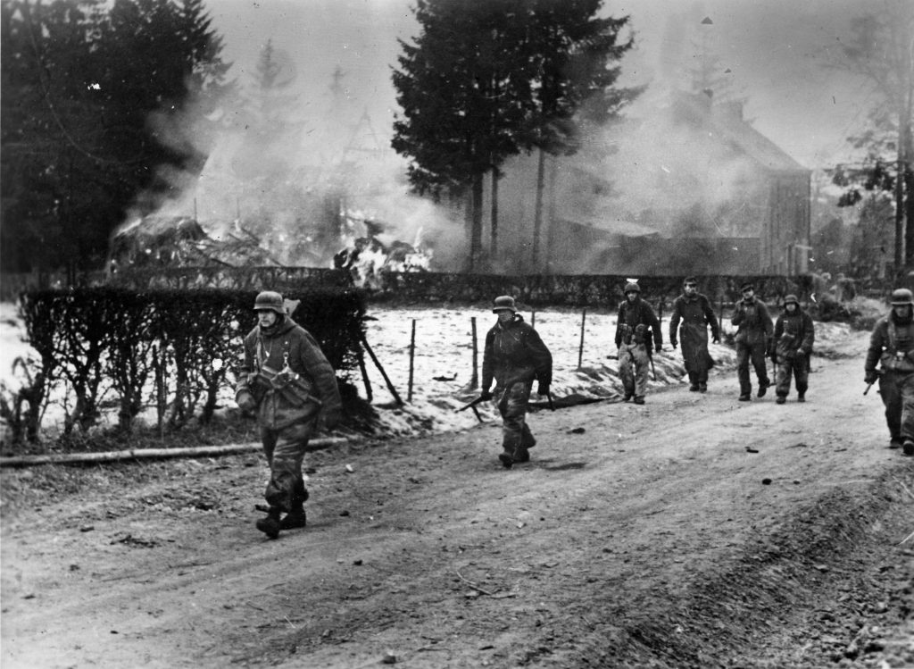 Responding to the British and Canadian advance through the Reichswald, German panzergrenadiers move forward through a small town. German resistance to Operation Veritable proved tenacious.