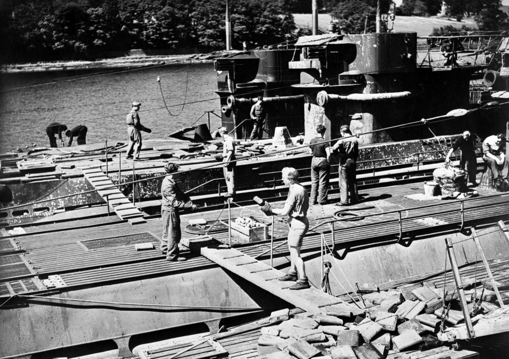 The crews of surrendered German U-boats unload equipment and supplies along the docks of Lisahally, Londonderry, Northern Ireland.