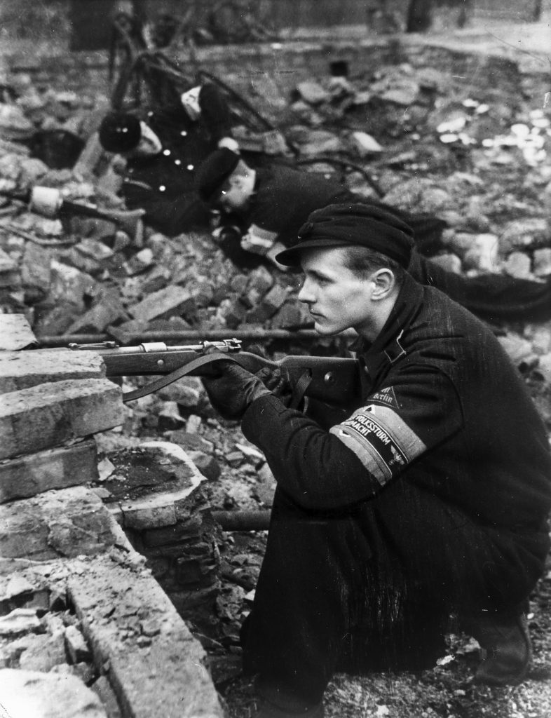 Teenage members of the Hitler Youth armed with Mauser rifles and Panzerfaust anti-tank weapons man a trench as they train to defend Berlin against the approaching Red Army.