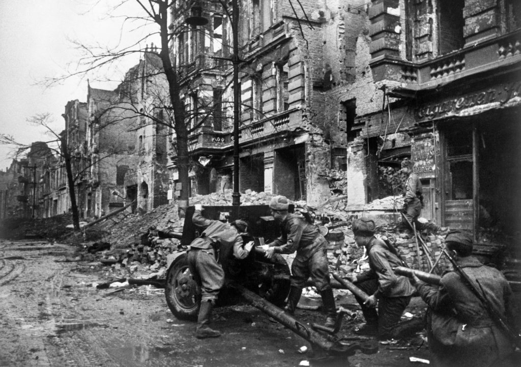 Red Army artillerymen service their weapon in a Berlin street. The Soviets suffered heavy casualties in the fighting but conquered the Nazi capital after a bitter struggle.