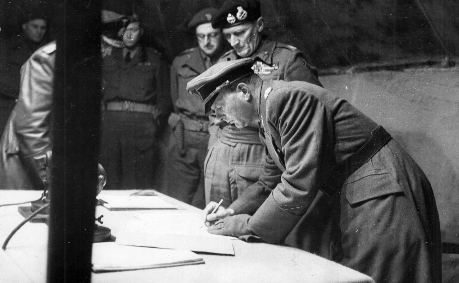 German General Eberhard Einzel signs surrender documents while Field Marshal <a href=