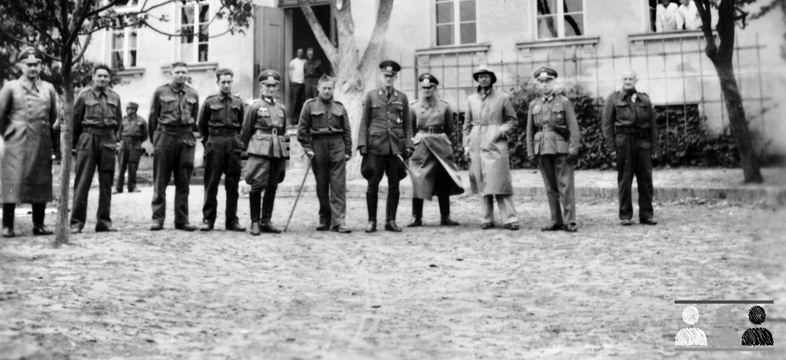 German officers and enlisted personnel stand in front of Oflag 64, a former reform school for boys that was converted into a somewhat unique prison camp for American officers during World War II.