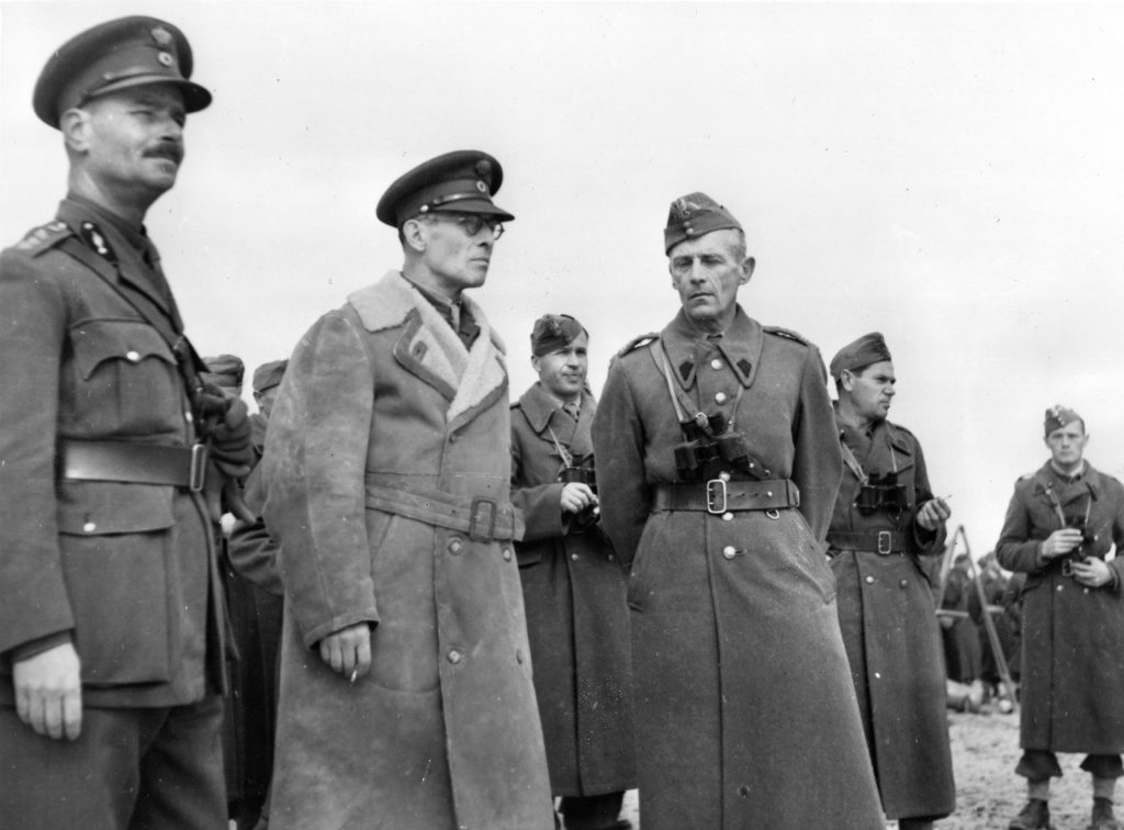King George II of the Hellenes (center) stands with Polish officers during an inspection of Greek troops that successfully escaped their occupied country and reached <a href=