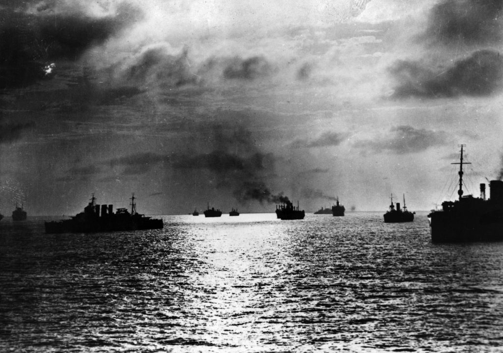 When the Japanese attacked Pearl Harbor, the  cruiser USS Pensacola was caught up in the confusion of the early days of American involvement in World War II while escorting troops and materiel to the Philippines. In this photo a convoy of ships assembles for a hazardous wartime voyage.