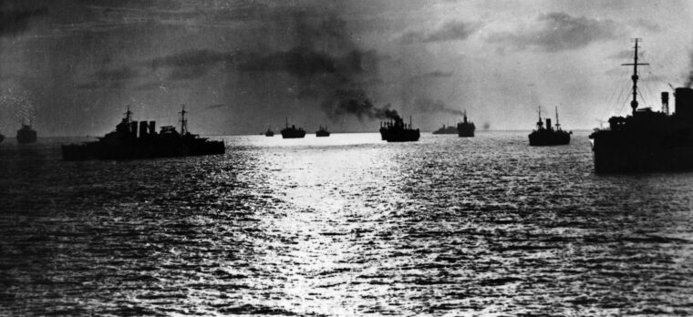 When the Japanese attacked Pearl Harbor, the cruiser USS Pensacola was caught up in the confusion of the early days of American involvement in World War II while escorting troops and materiel to the Philippines. In this photo a convoy of ships assembles for a hazardous wartime voyage.