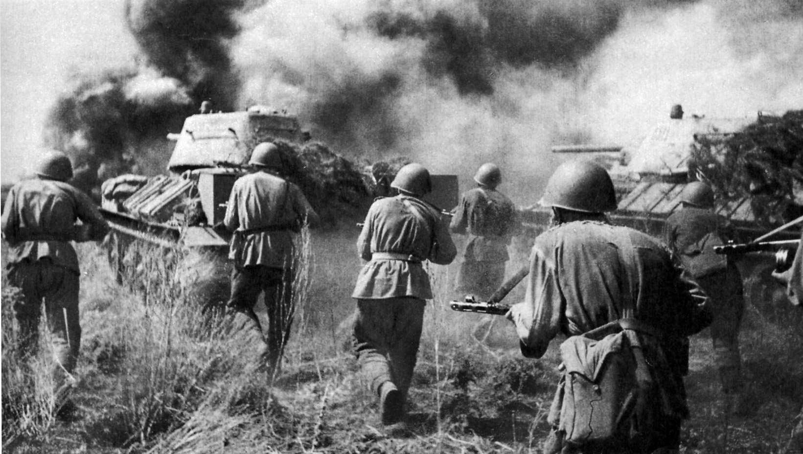 Soviet troops advance behind the cover of a tank during the desperate fighting at Kursk in the  summer of 1943. Rokossovsky believed that Stalin had entrusted him with a key role that led to the defeat of the German forces and doomed their Operation Citadel to failure.