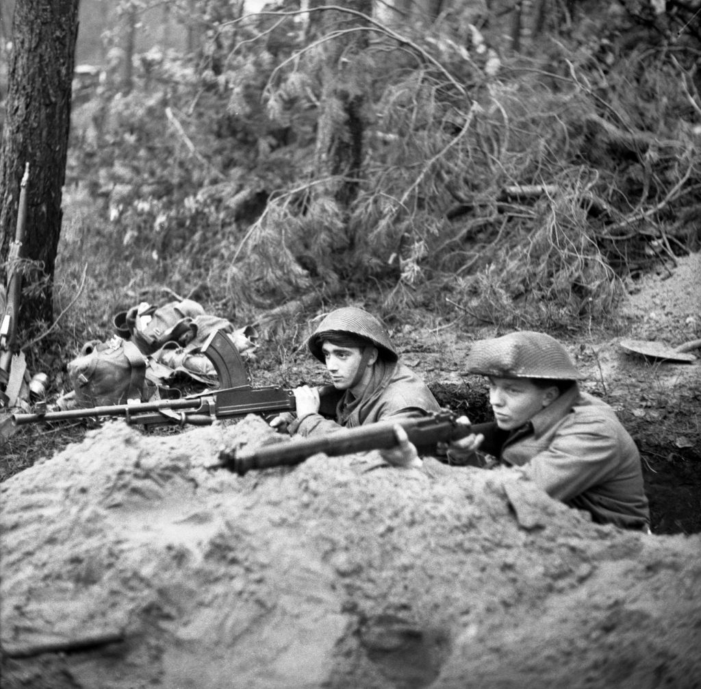 Men of the 6th Royal Welsh Fusiliers man a trench in the Reichswald. During the early stages of Operation Veritable, the Germans often put up a stout defense and then withdrew to sturdier fortifications deeper in the forest.