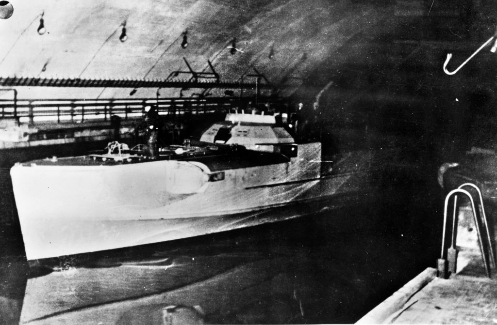 A German E-boat lies moored in a concrete shelter intended to protect it from Allied bombs. The coming of the Tallboy rendered such shelters vulnerable from the air.