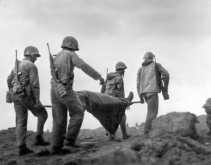 Marines evacuate an injured comrade to the rear in February 1945. 