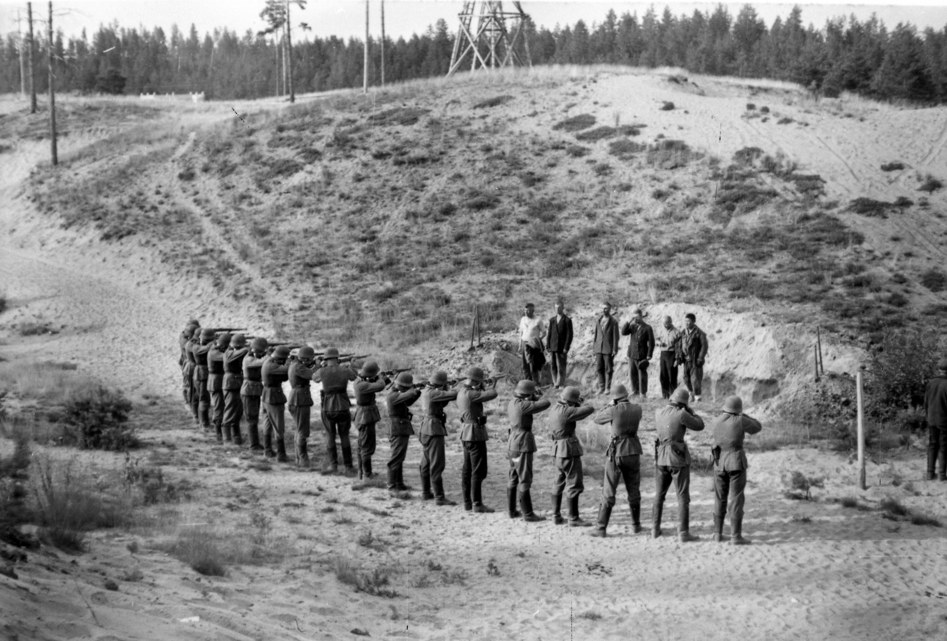 A Nazi firing squad executes six Soviet partisans “somewhere in the USSR,” September 1941.  German death squads (Einsatzgruppen) followed the frontline troops during the invasion of the Soviet Union, rounding up and killing hundreds of thousands of Jews and others.