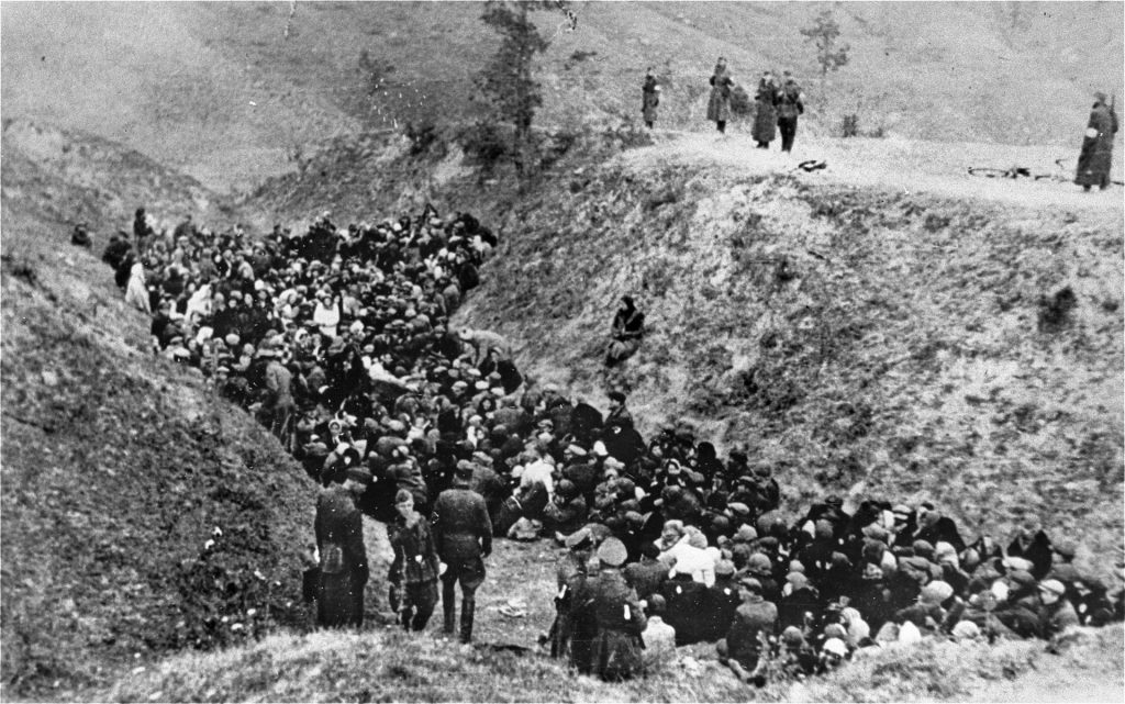 Thousands of Jewish men, women, and children fill a pit near the Soviet town of Zdolbunov as their German captors prepare to slaughter them, October 1942.