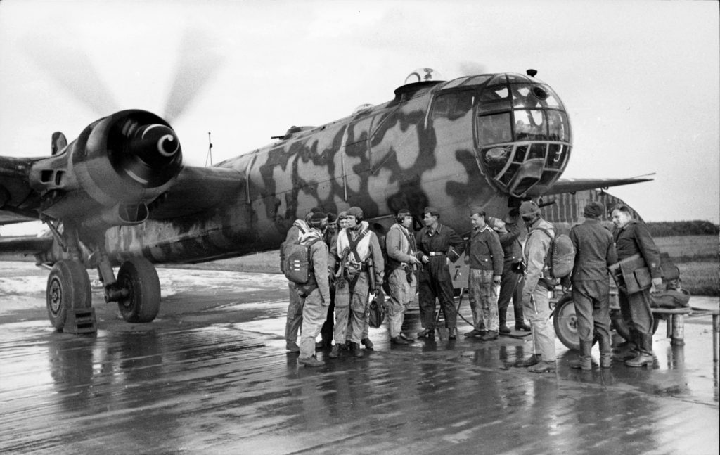 Crew members gather around an HE-177 at Tannenberg, East Prussia, before a mission. The bomber normally carried a crew of five. 